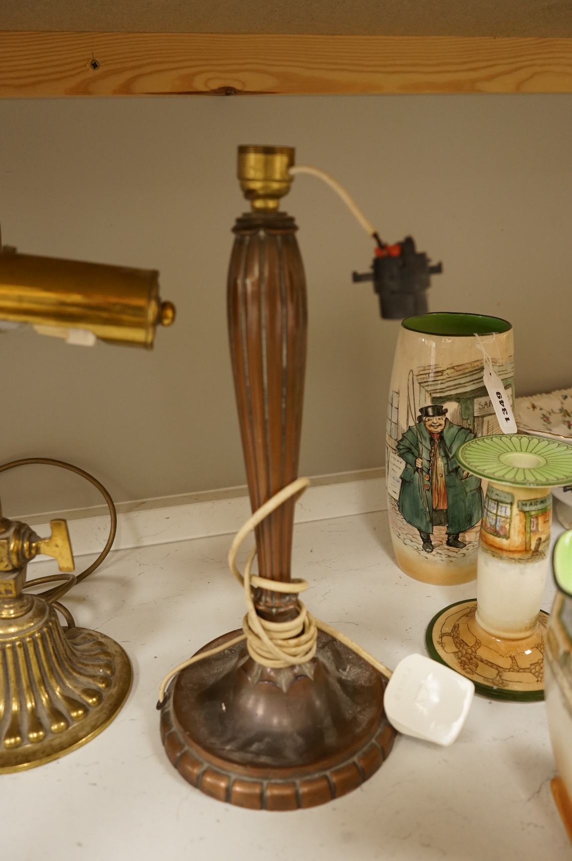 A copper table lamp and a brass students lamp